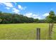 Vast green field enclosed by a wire fence at 6434 Saint Anthony Dr, Meggett, SC 29449