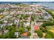 Charleston neighborhood aerial showcasing verdant trees, historic homes, and city streets with the Ravenel Bridge beyond at 71 E Bay St, Charleston, SC 29401
