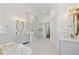Luxurious bathroom with marble floors, a glass shower, a standalone tub, and dual vanities at 71 E Bay St, Charleston, SC 29401