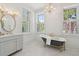 Elegant bathroom with a clawfoot tub, marble floors, dual sinks, and stylish fixtures at 71 E Bay St, Charleston, SC 29401