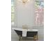 Close up of a luxurious clawfoot bathtub with gold fixtures and a view from the window at 71 E Bay St, Charleston, SC 29401