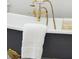 Detailed view of the gold faucet and accessories on a clawfoot bathtub at 71 E Bay St, Charleston, SC 29401