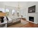 Bright bedroom featuring large windows, a fireplace, and a comfortable bed at 71 E Bay St, Charleston, SC 29401
