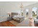 Spacious bedroom with hardwood floors, arched windows, and chandelier at 71 E Bay St, Charleston, SC 29401