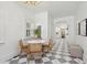 Bright dining room features marble checkerboard floors, grand lighting, and custom millwork throughout at 71 E Bay St, Charleston, SC 29401