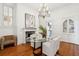 Bright dining room with a glass table, fireplace, and elegant chandelier at 71 E Bay St, Charleston, SC 29401