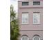 Charming exterior detail featuring decorative trim and large windows, with a palm tree adding a tropical touch at 71 E Bay St, Charleston, SC 29401
