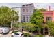 Street view showcases stately townhouses with mature trees and manicured sidewalk at 71 E Bay St, Charleston, SC 29401