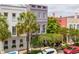 Elegant townhomes featuring a private balcony shaded by lush landscaping at 71 E Bay St, Charleston, SC 29401