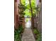 Charming garden path with decorative wrought iron gate, leading to lush greenery and natural light at 71 E Bay St, Charleston, SC 29401