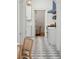 Hallway leading to an updated kitchen with a blue stove and luxury marble checkerboard flooring at 71 E Bay St, Charleston, SC 29401