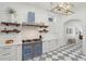 Stylish kitchen boasts a blue stove, floating wood shelves, and checkered marble floors at 71 E Bay St, Charleston, SC 29401