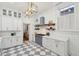 Bright, renovated kitchen with checkered floors, white cabinets, and stainless steel appliances at 71 E Bay St, Charleston, SC 29401