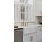 Farmhouse sink with high-end gold fixtures in a bright kitchen with white cabinetry and marble countertops at 71 E Bay St, Charleston, SC 29401