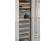 Stainless steel wine refrigerator features a clear glass door and wood shelving to display wine collection at 71 E Bay St, Charleston, SC 29401