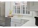 Sunny kitchen featuring a farmhouse sink, stainless steel appliances, and marble countertops at 71 E Bay St, Charleston, SC 29401