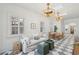 Stylish living room featuring checkerboard floors, a modern sofa, and abundant natural light at 71 E Bay St, Charleston, SC 29401