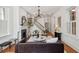 Bright living room showcasing fireplace, grand staircase, chandelier, and stylish furnishings at 71 E Bay St, Charleston, SC 29401