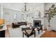 Bright living room with hardwood floors, fireplace, chandelier, and classic architectural details at 71 E Bay St, Charleston, SC 29401