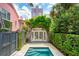 Backyard features a private plunge pool, manicured landscaping, and a double french door entrance at 71 E Bay St, Charleston, SC 29401