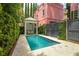 Backyard boasts a plunge pool, manicured hedges, a charming gazebo, and pink home at 71 E Bay St, Charleston, SC 29401