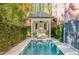 Secluded backyard pool featuring a charming cabana with a swing and lush greenery at 71 E Bay St, Charleston, SC 29401