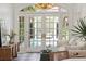Sitting room with checkered floors, white sofa, and a view of the pool through the French doors at 71 E Bay St, Charleston, SC 29401