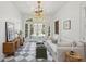 Sitting room with checkered floors, white sofa, and a view of the pool through the French doors at 71 E Bay St, Charleston, SC 29401