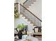 Elegant staircase with wrought iron railing, paired with stylish seating and decorative plants at 71 E Bay St, Charleston, SC 29401