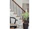 Elegant staircase with wrought iron railing, paired with stylish seating at 71 E Bay St, Charleston, SC 29401