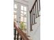 Staircase featuring wood and wrought iron details and decorative glass doors to the garden at 71 E Bay St, Charleston, SC 29401