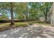 Large backyard with mature trees, and concrete patio - perfect for entertaining at 7639 Hillandale Rd, North Charleston, SC 29420