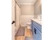 Stylish bathroom featuring blue vanity, wainscotting, and a shower and tub combo at 7639 Hillandale Rd, North Charleston, SC 29420