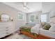 Cozy bedroom features a bed, dresser, natural light and an exterior door at 7639 Hillandale Rd, North Charleston, SC 29420