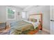 Comfortable bedroom features a bed, dresser, natural light and an exterior door at 7639 Hillandale Rd, North Charleston, SC 29420
