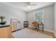 This spare bedroom includes a large window, stylish rug, and a well-lit desk area at 7639 Hillandale Rd, North Charleston, SC 29420