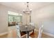 Charming dining area with views into the living room, hardwood floors, and modern chandelier at 7639 Hillandale Rd, North Charleston, SC 29420