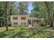 Charming two-story home with well-maintained lawn, mature trees, and inviting front porch at 7639 Hillandale Rd, North Charleston, SC 29420