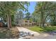 Charming two-story home with well-manicured lawn, mature trees, and a long driveway at 7639 Hillandale Rd, North Charleston, SC 29420