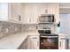 Well-equipped kitchen featuring white countertops, stainless steel appliances, and ample cabinet space at 7639 Hillandale Rd, North Charleston, SC 29420