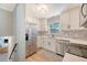 Modern kitchen with stainless steel appliances, white cabinets, and stylish backsplash at 7639 Hillandale Rd, North Charleston, SC 29420