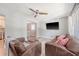 Cozy living room featuring hardwood floors, a ceiling fan, and natural light from large windows at 7639 Hillandale Rd, North Charleston, SC 29420