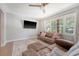 Comfortable living room with a plush sofa, decorative pillows, and large windows offering backyard views at 7639 Hillandale Rd, North Charleston, SC 29420