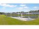 Scenic aerial view of homes surrounding a serene pond with a fountain at 768 Trotters Ln, Moncks Corner, SC 29461
