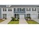 Charming townhome exteriors feature multi-toned siding, attached garages, and manicured landscaping at 768 Trotters Ln, Moncks Corner, SC 29461