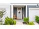 Charming front porch with rocking chair, welcome mat, and well-manicured landscaping at 768 Trotters Ln, Moncks Corner, SC 29461