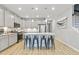 Bright kitchen featuring gray cabinetry, stainless steel appliances, island with seating, and hardwood floors at 768 Trotters Ln, Moncks Corner, SC 29461