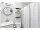 Modern bathroom featuring a decorative mirror, shelves, and a shower with patterned curtain at 7935 Parklane Ct # A, North Charleston, SC 29418