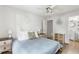 Bright bedroom featuring a ceiling fan, wood floors, and light blue bedspread at 7935 Parklane Ct # A, North Charleston, SC 29418