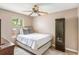 Neutral toned bedroom featuring a ceiling fan, wood floors, and a window looking out to greenery at 7935 Parklane Ct # A, North Charleston, SC 29418